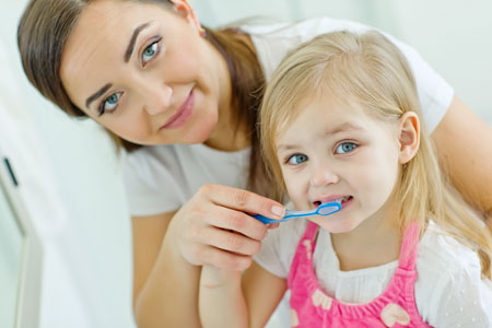 Mom and Daughter brushing their teeth