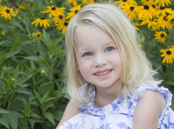 Smiling girl with yellow flowers
